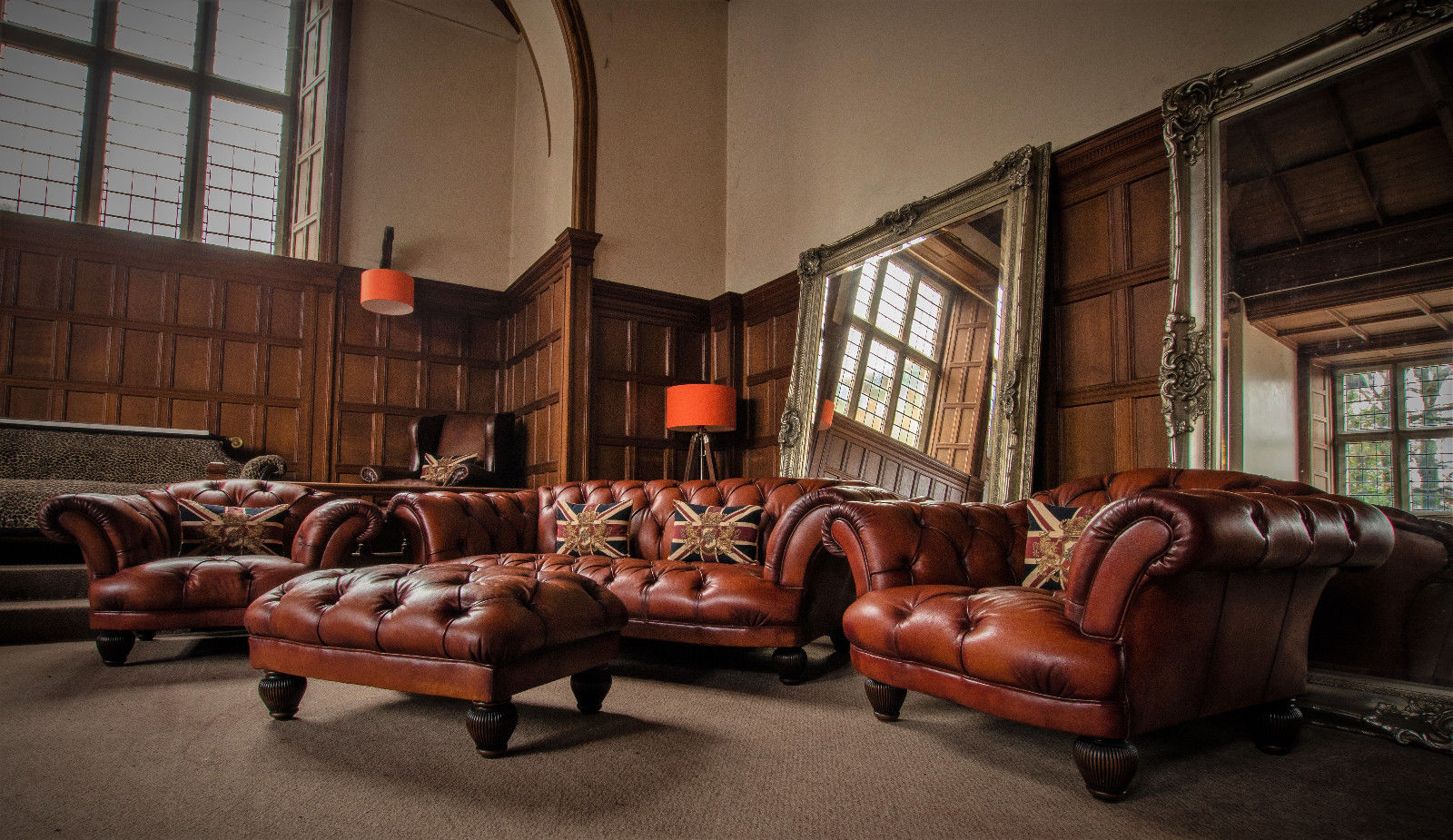 Hand-dyed leather Chesterfield suite in a wood-panelled hall